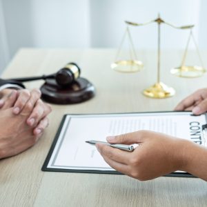 Male lawyer or counselor discussing negotiation legal case with client meeting with document contract in office, law and justice, attorney, lawsuit concept.